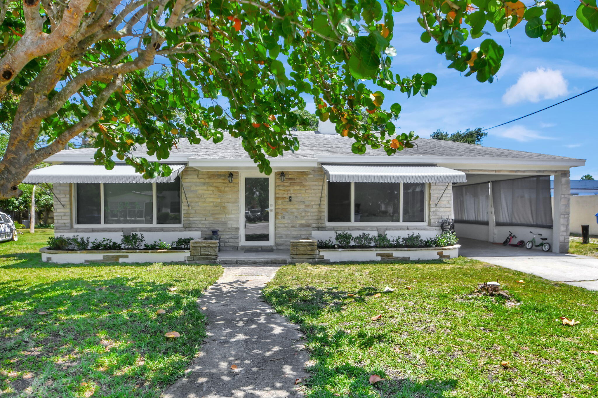 a view of a house with a yard and sitting area