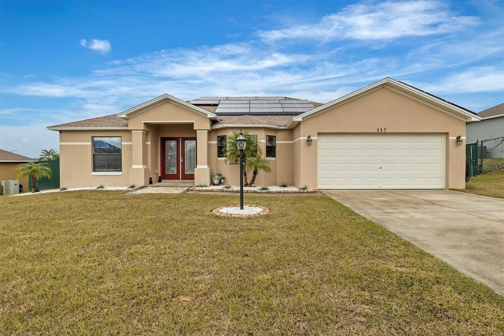 a front view of a house with a yard