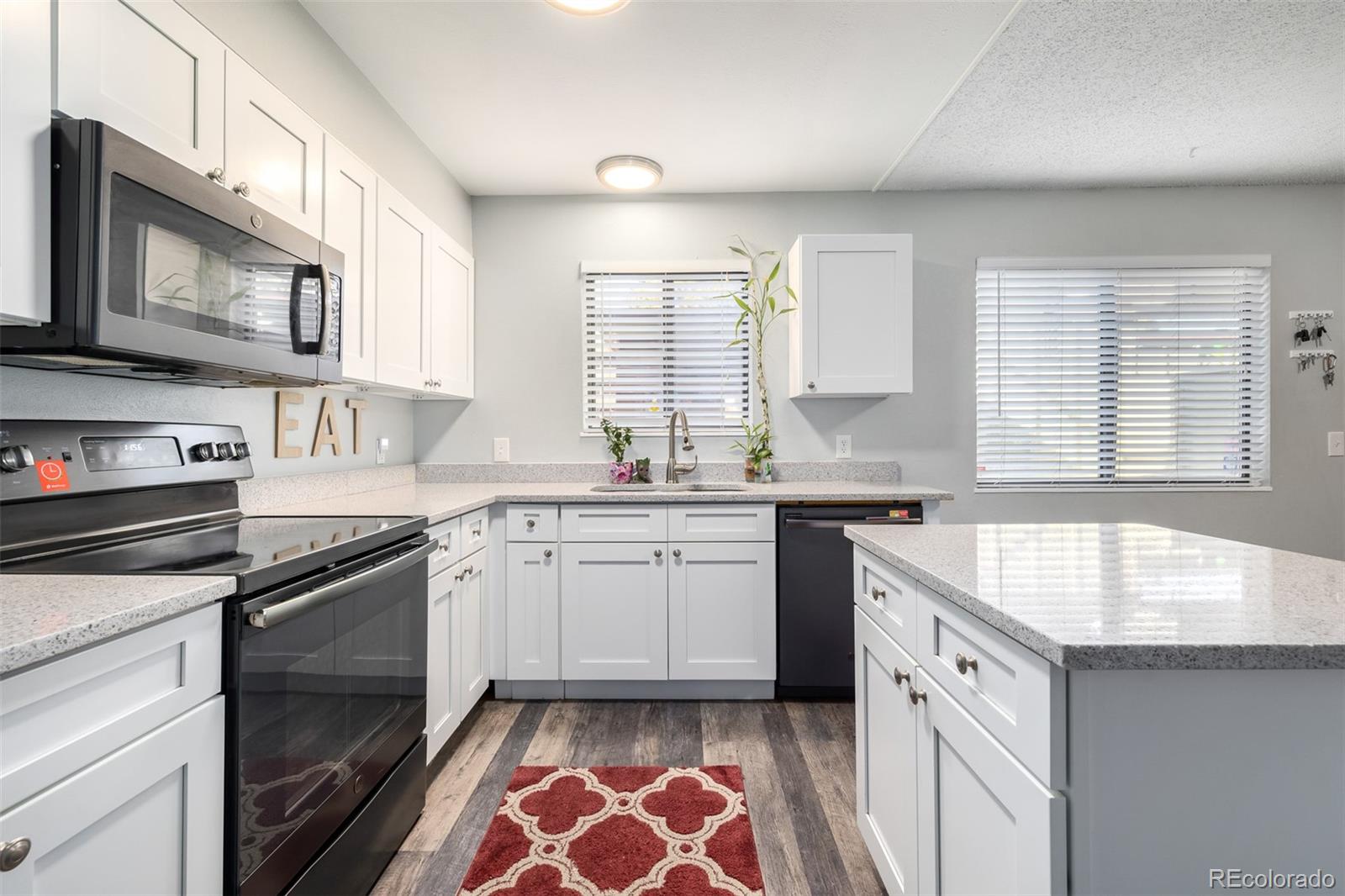 a kitchen that has a sink and a stove in it