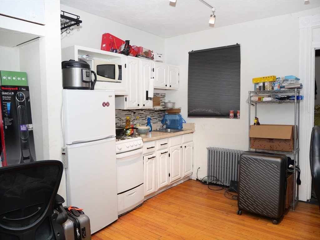 a kitchen with stainless steel appliances a stove a refrigerator and a refrigerator