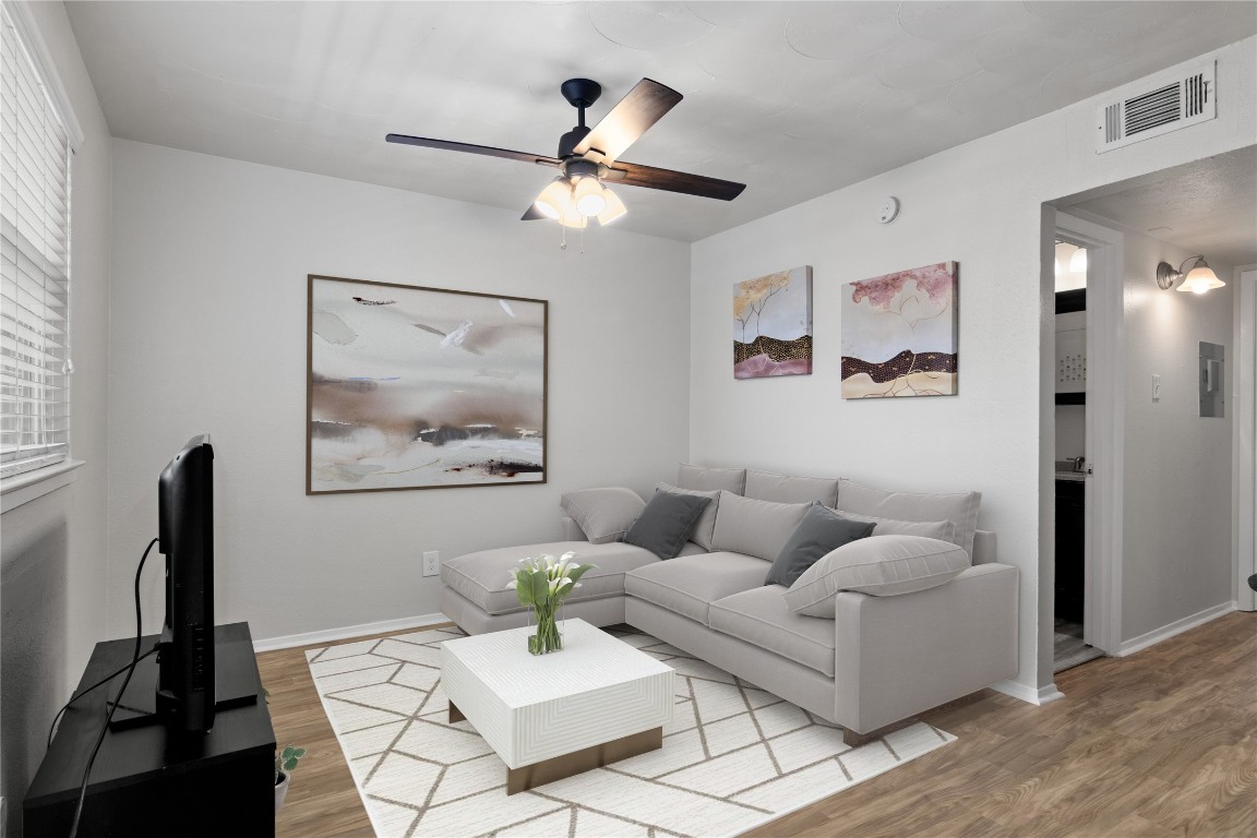 Spacious living room with new flooring (Virtually staged)