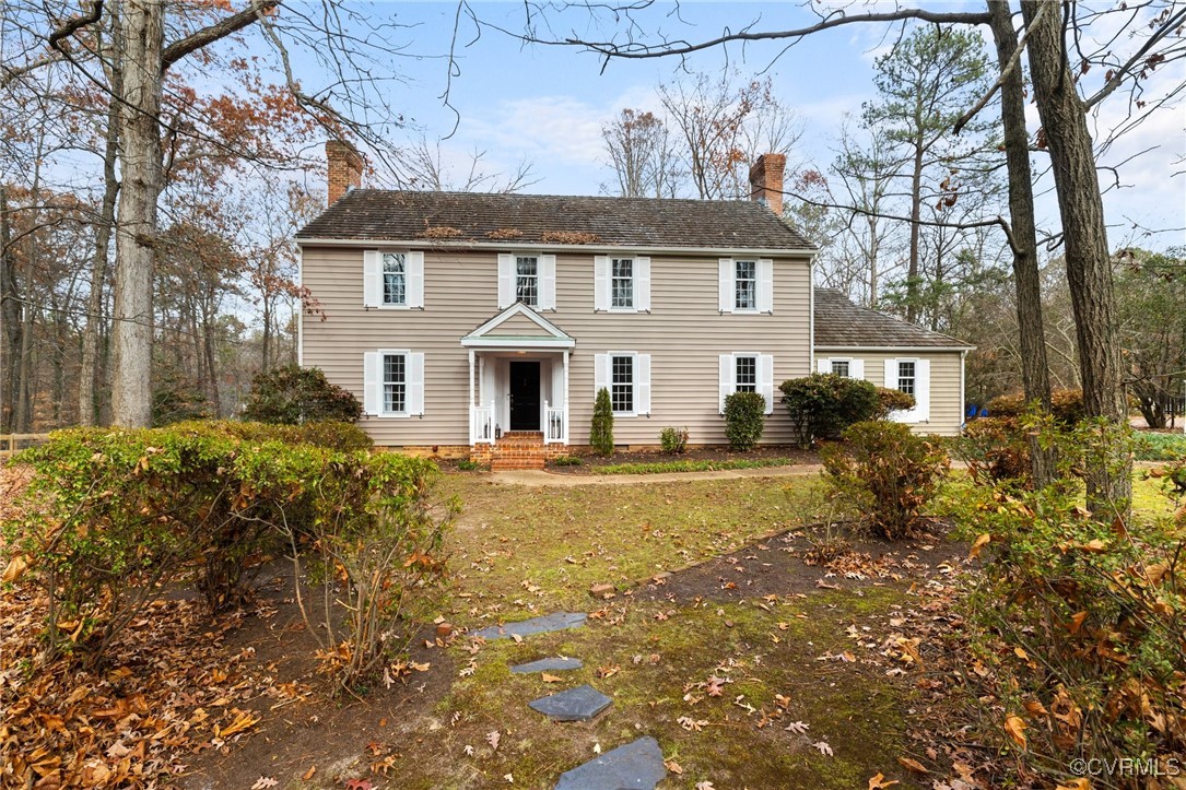 a view of house with backyard