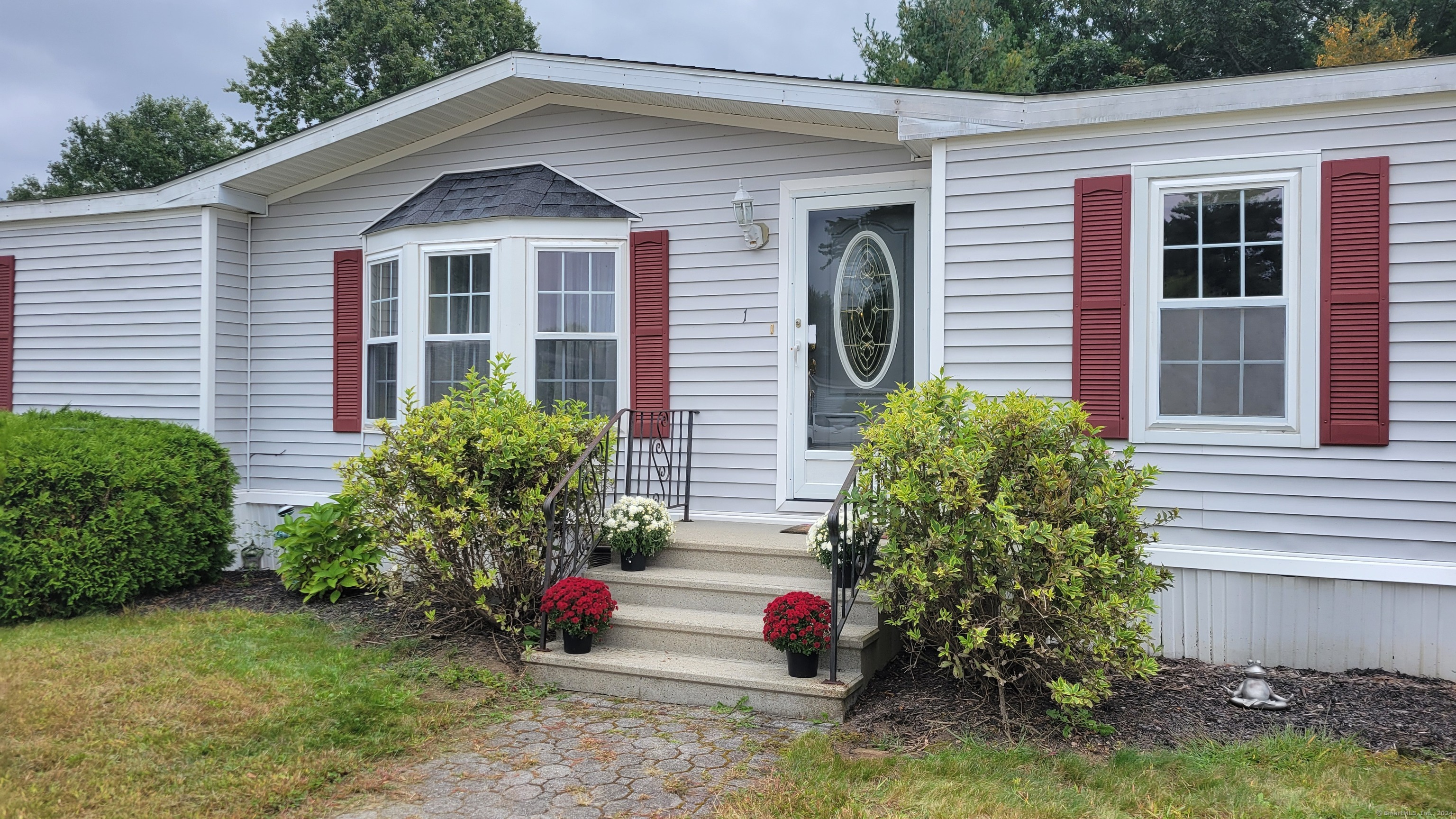 a front view of a house with garden