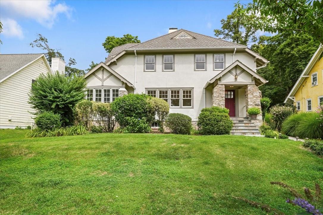 Tudor home featuring a front yard