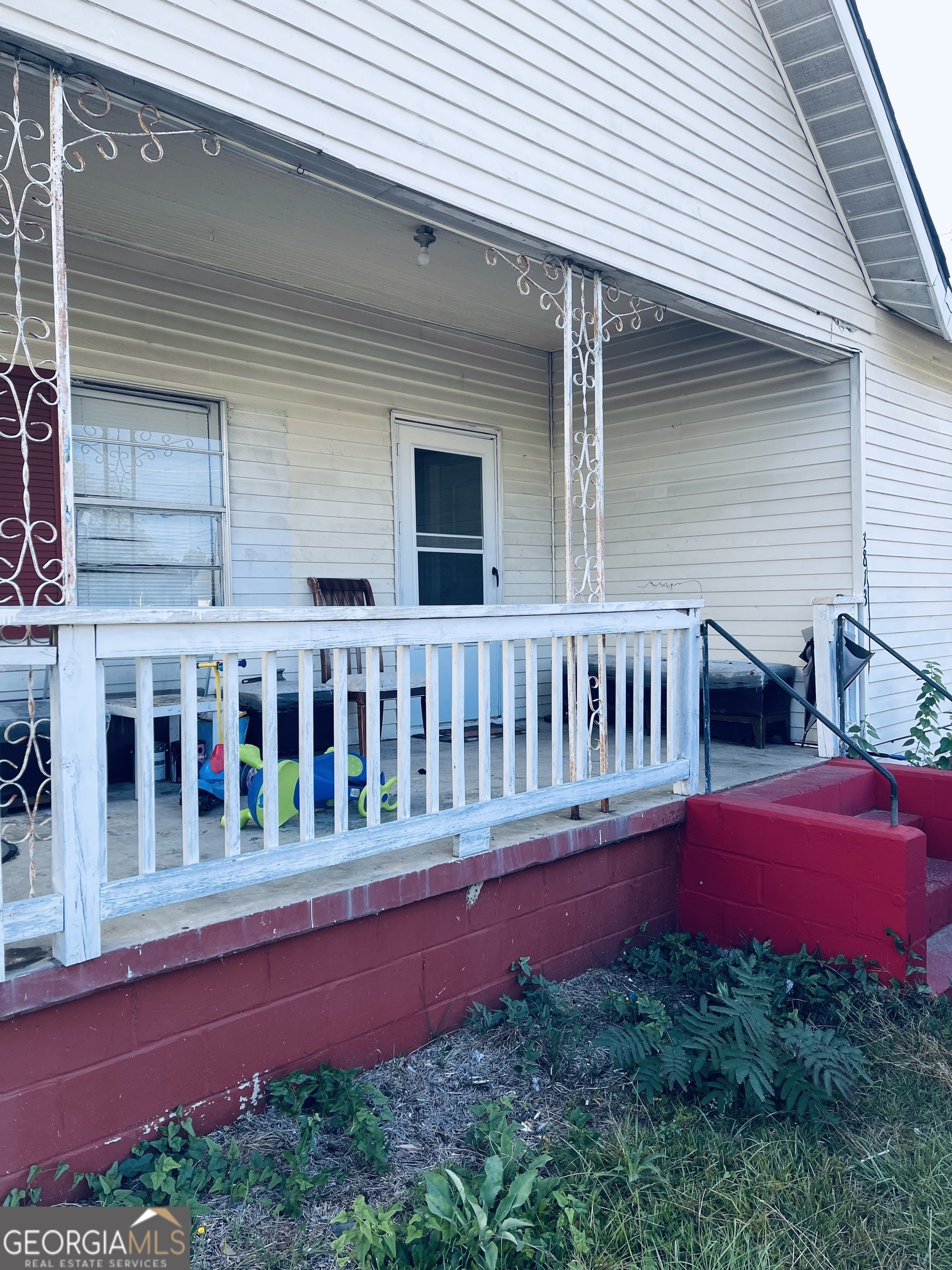 a view of a house with deck and a yard