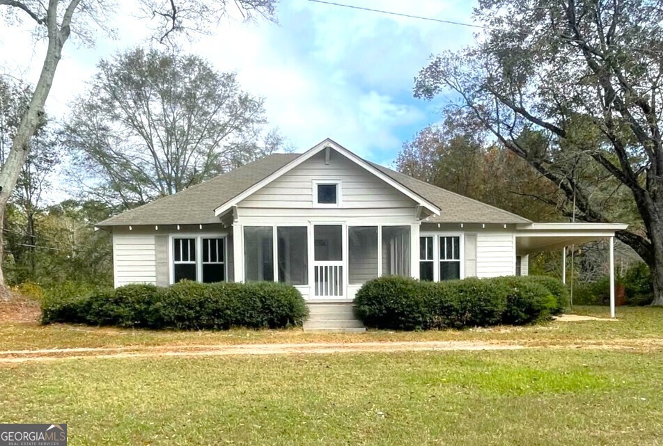 a front view of a house with a garden