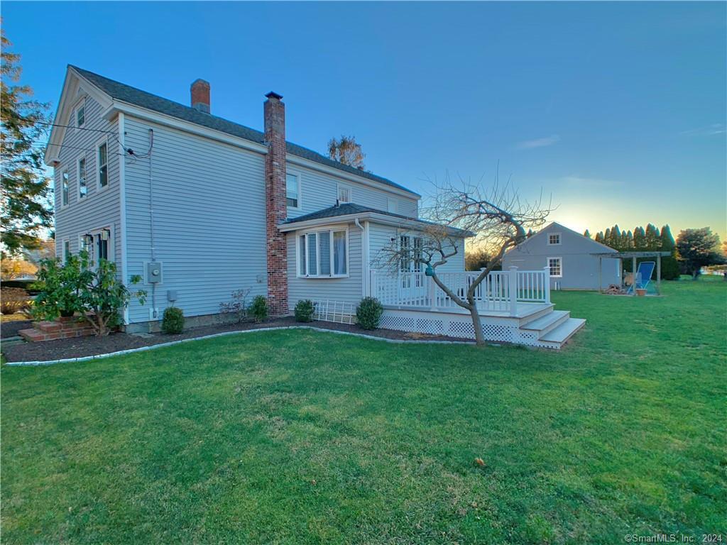 a view of a house with a backyard