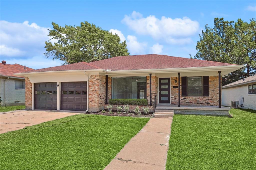 a front view of a house with a yard and porch