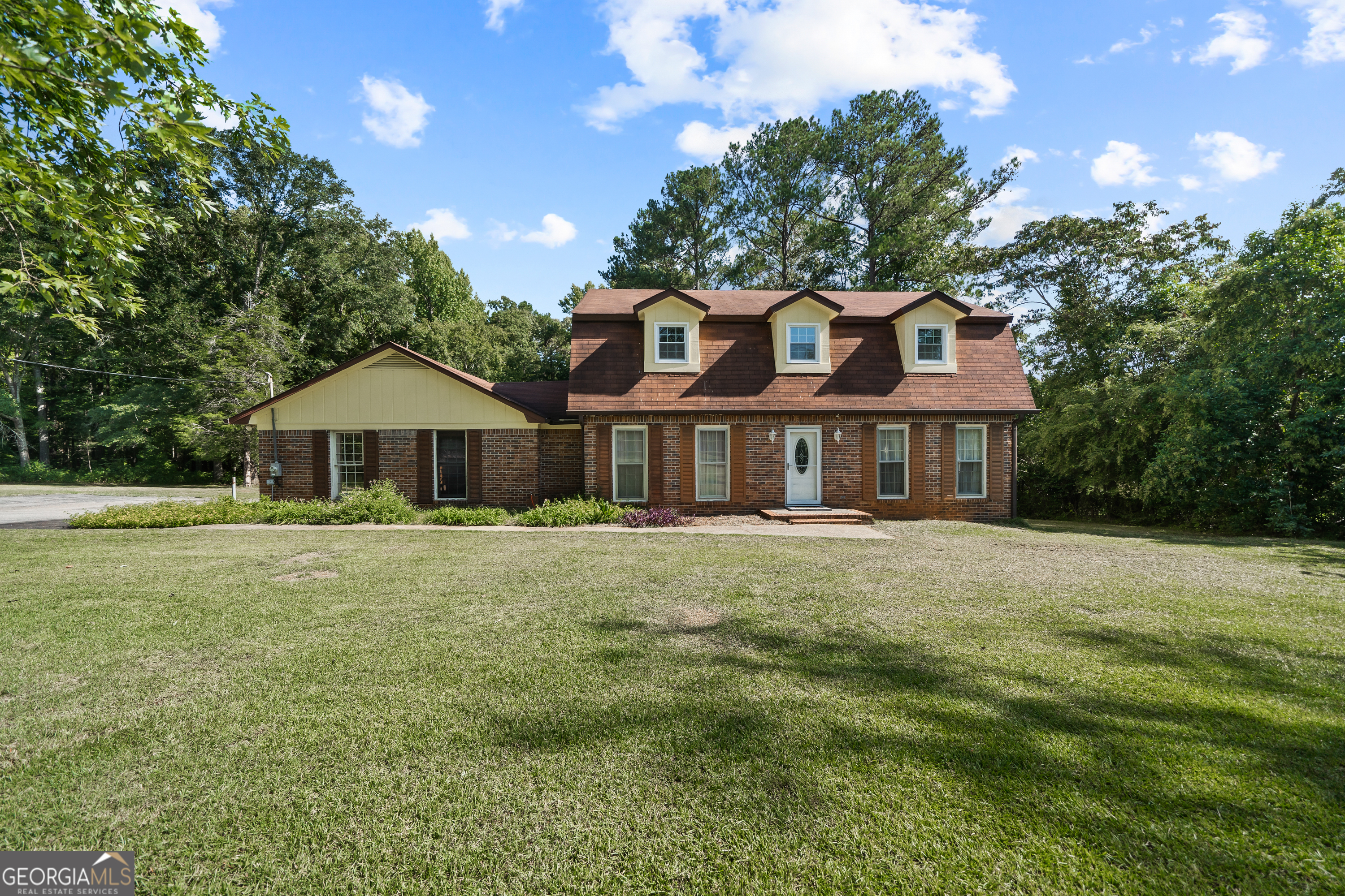 a front view of a house with a garden