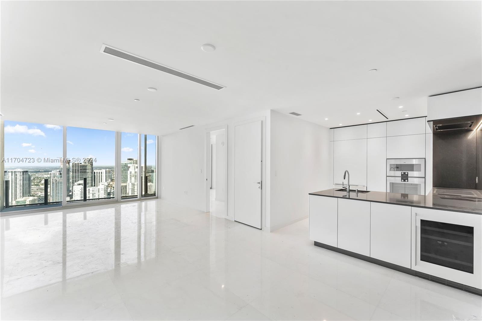 a kitchen with stainless steel appliances a refrigerator and a stove top oven