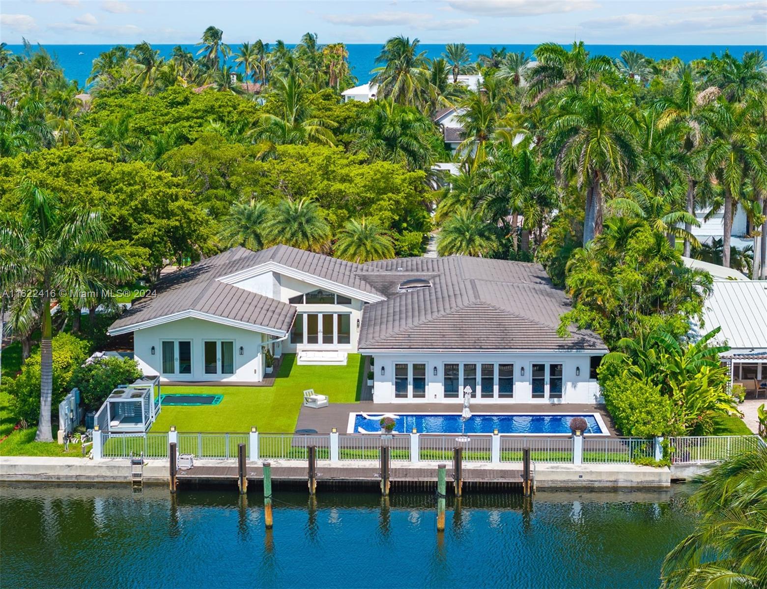 a aerial view of a house with swimming pool and sitting area