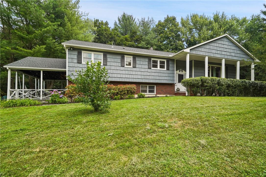 a front view of house with yard and green space