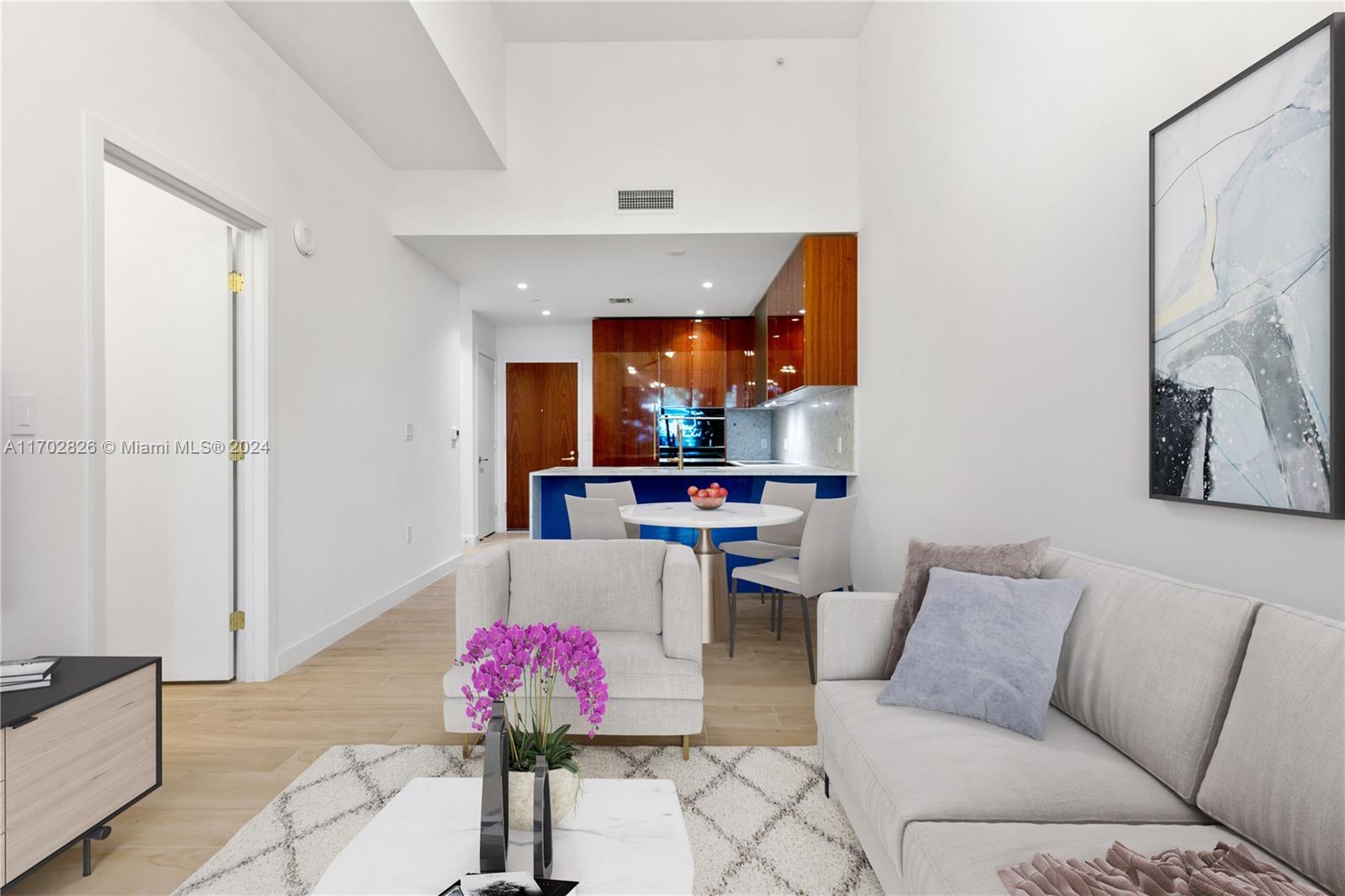 a living room with furniture and a potted plant