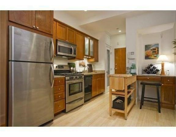 a kitchen with stainless steel appliances a refrigerator and a stove top oven