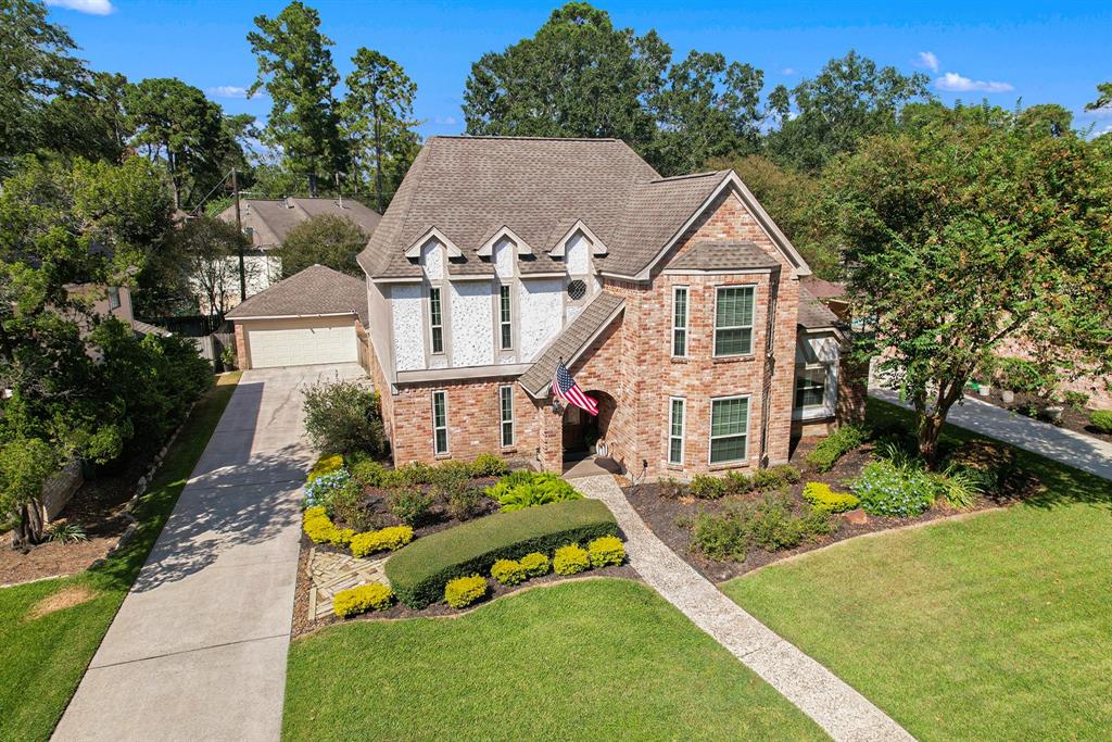 a aerial view of a house with a yard table and chairs