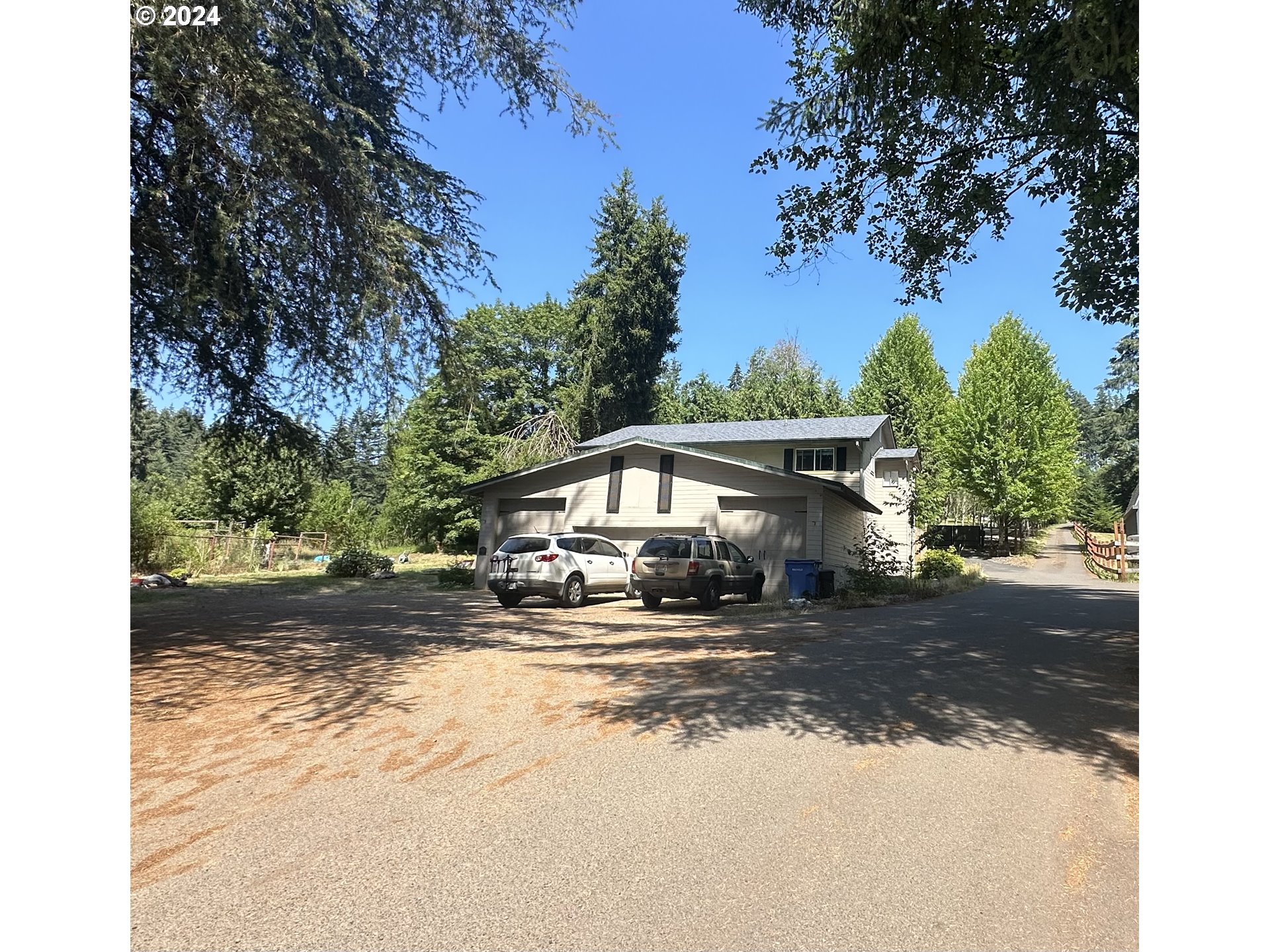 a view of a house with a yard next to a road