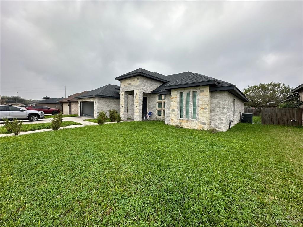 Prairie-style house with a garage and a front lawn