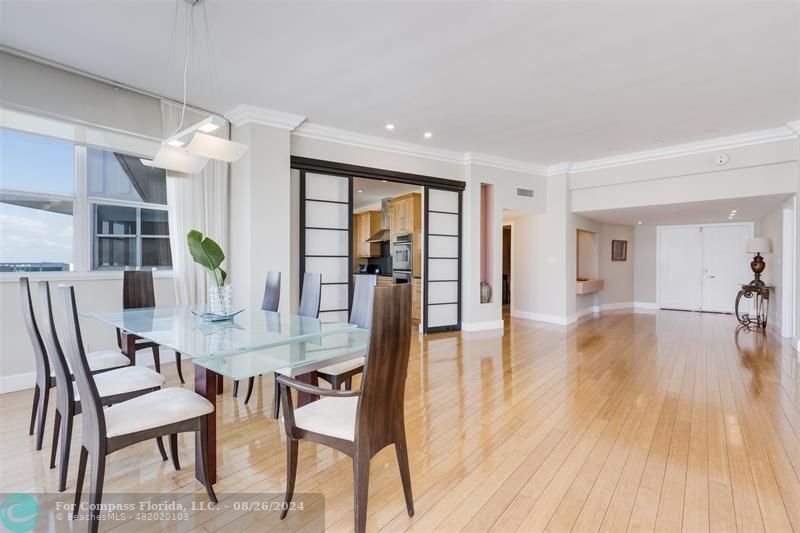 a view of a dining room with furniture and wooden floor