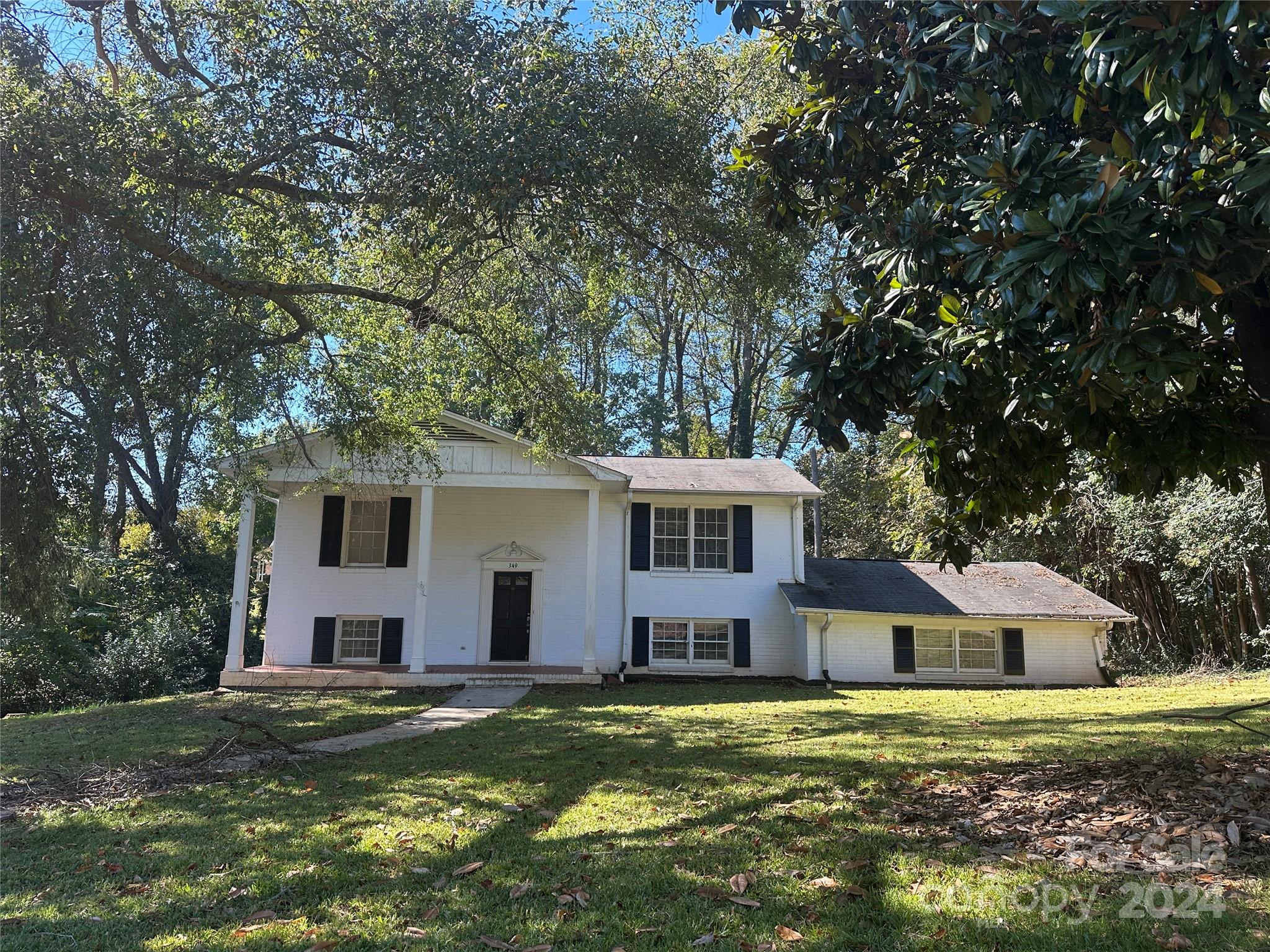 a front view of a house with a garden