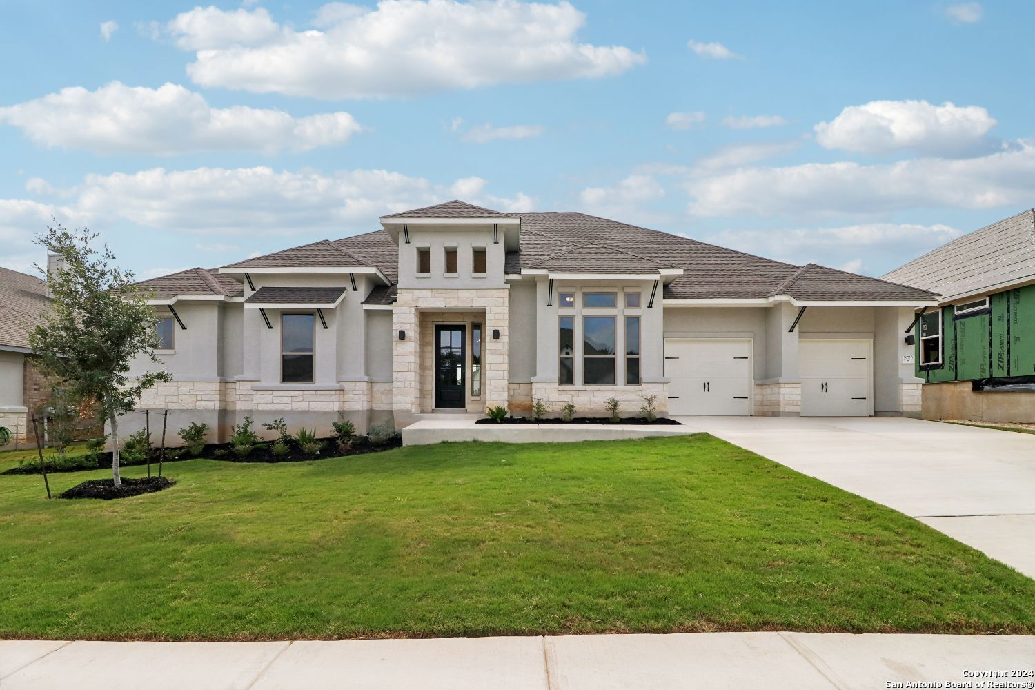 a front view of a house with a garden