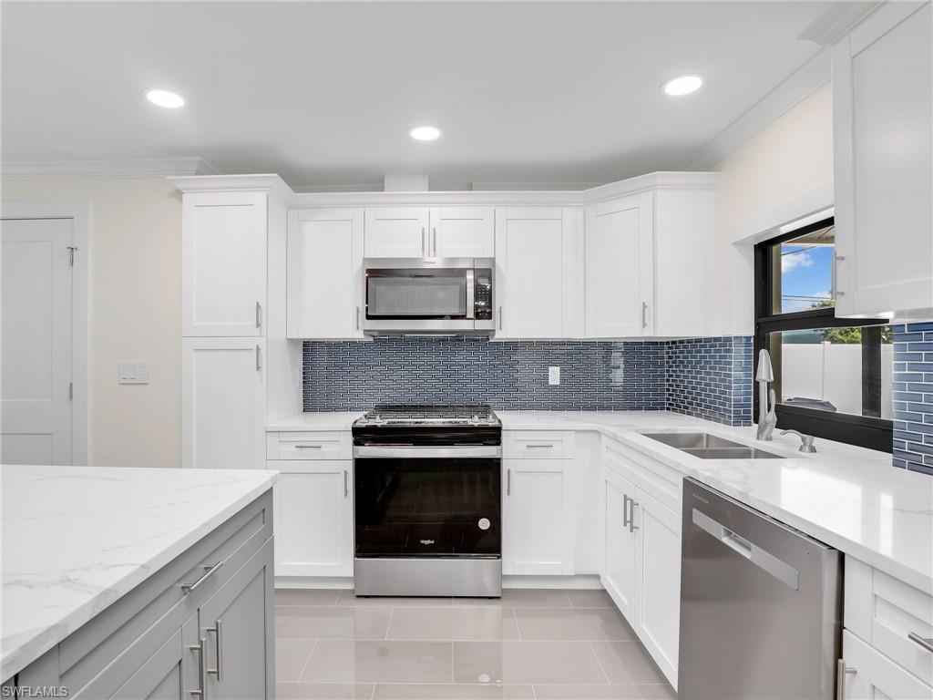 a kitchen with a sink stove and microwave