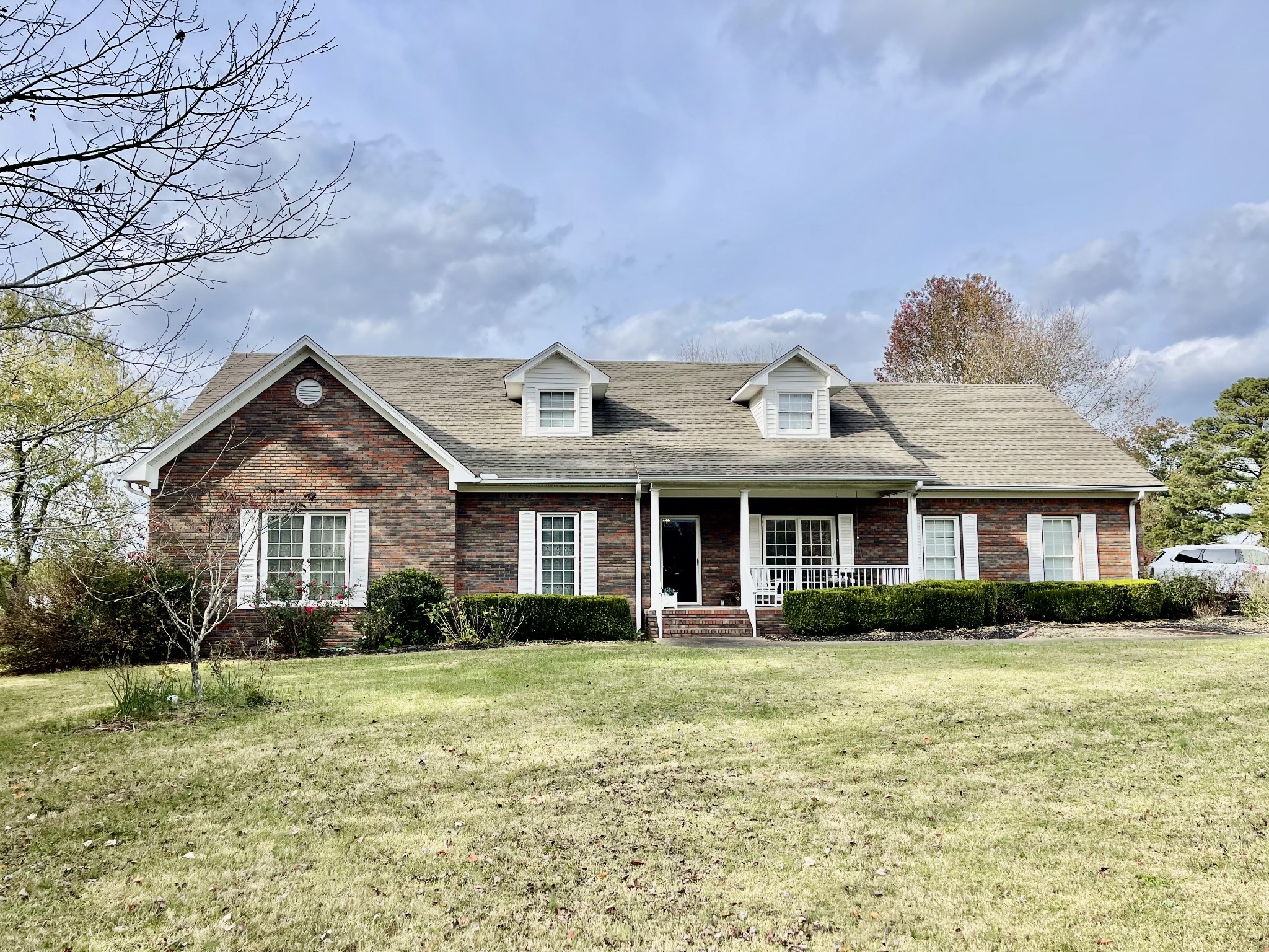 a front view of house with yard and green space