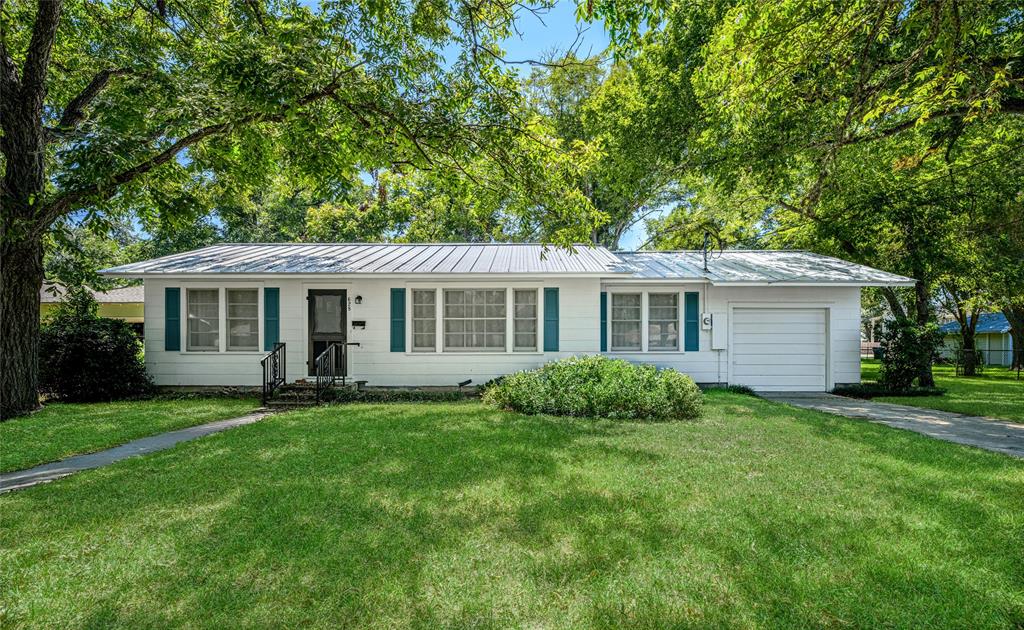 a front view of house with yard and green space