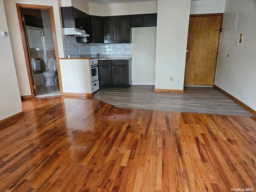 a view of kitchen with cabinets and wooden floor