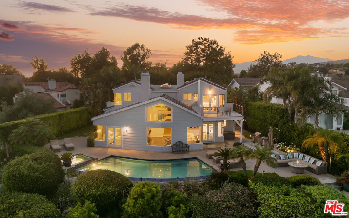 a aerial view of a house with a yard lake view and mountain view