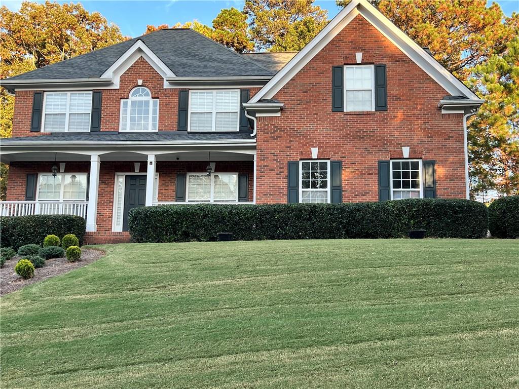 a front view of a house with a yard