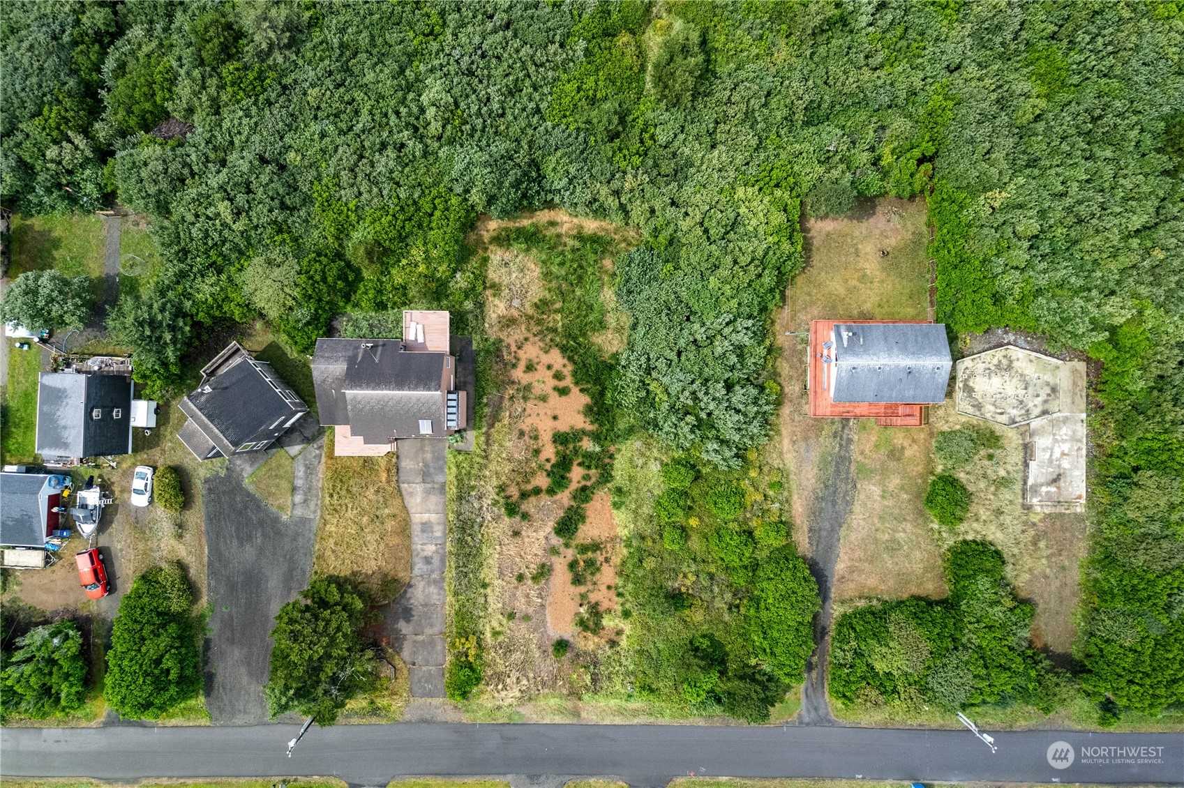 an aerial view of a house with outdoor space garden and tall trees