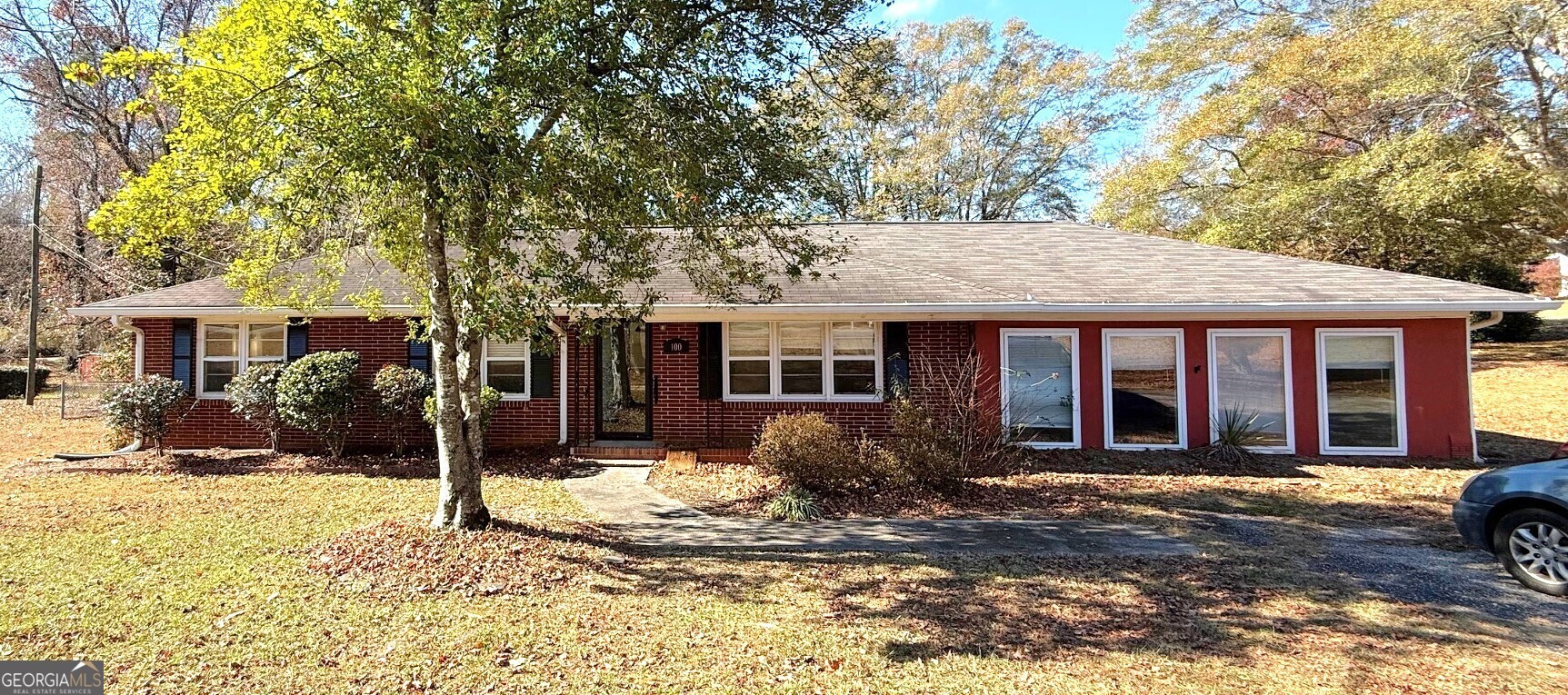 a front view of a house with a yard outdoor seating and garage