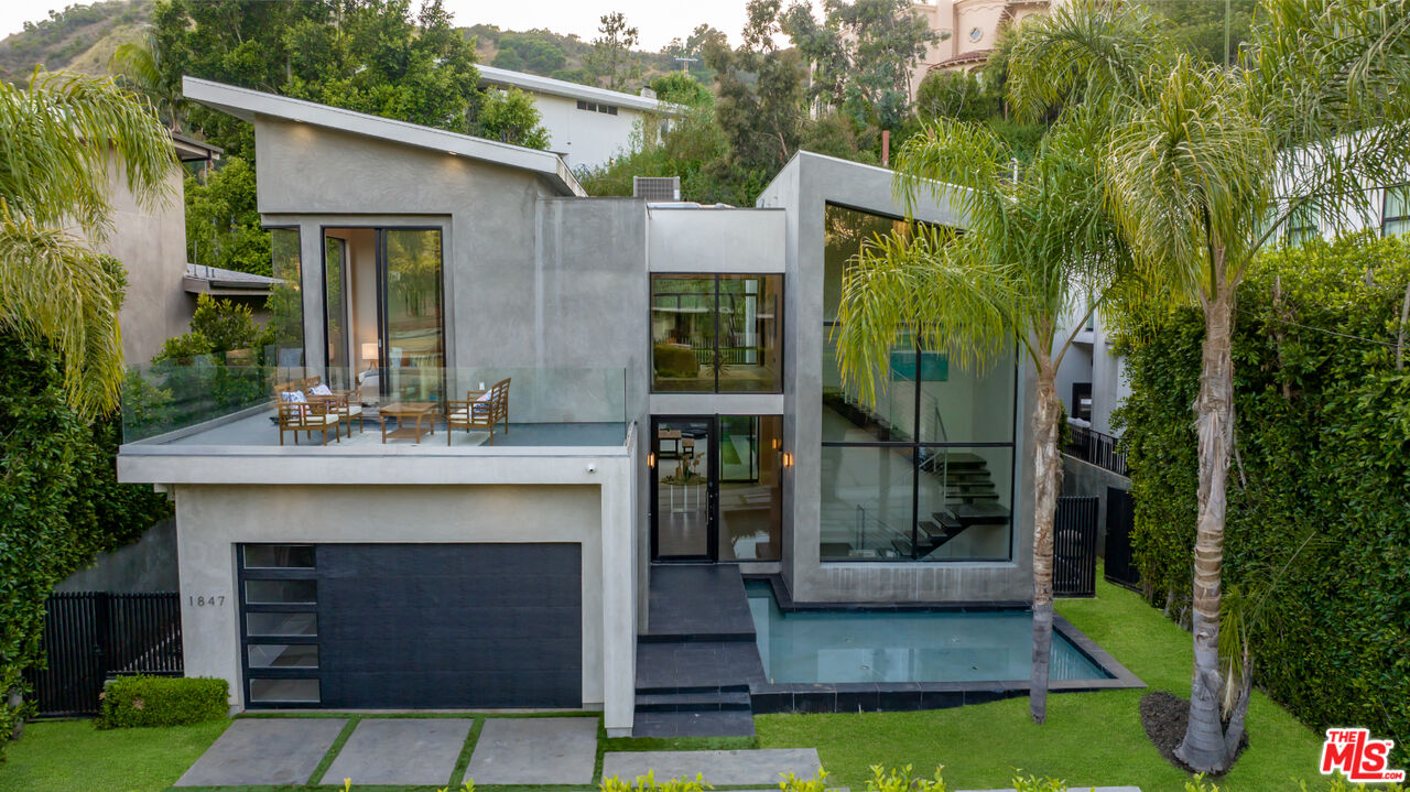 a front view of a house with a garden