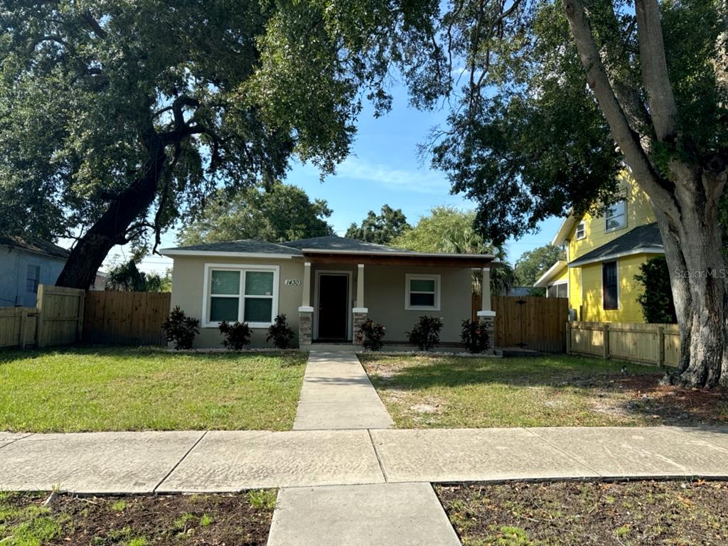 a house that has a tree in front of it