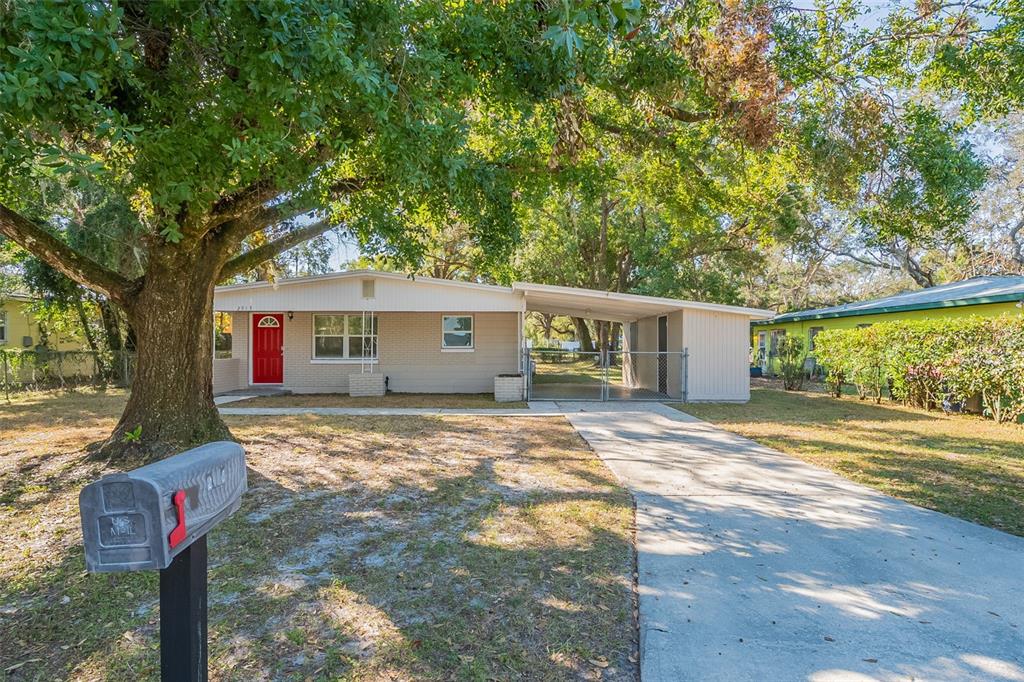 a front view of a house with a yard and trees