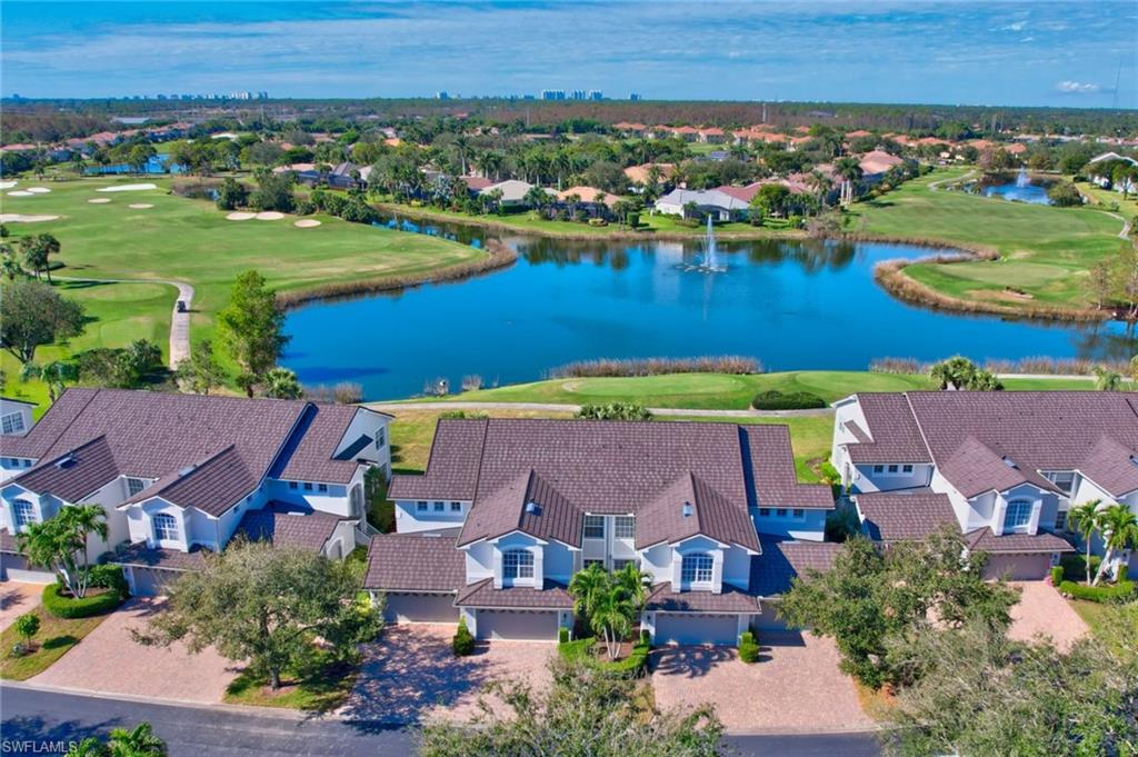 an aerial view of residential houses with outdoor space and lake view