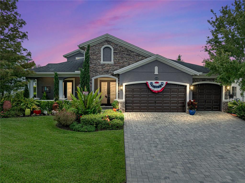 a front view of a house with a yard and garage