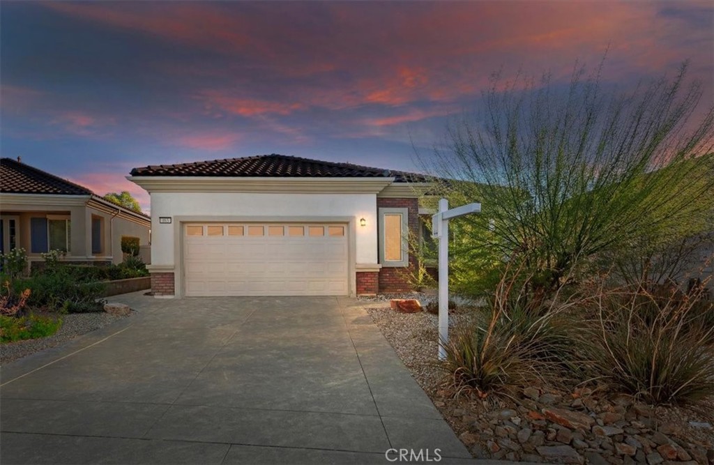 a view of a house with a yard and garage