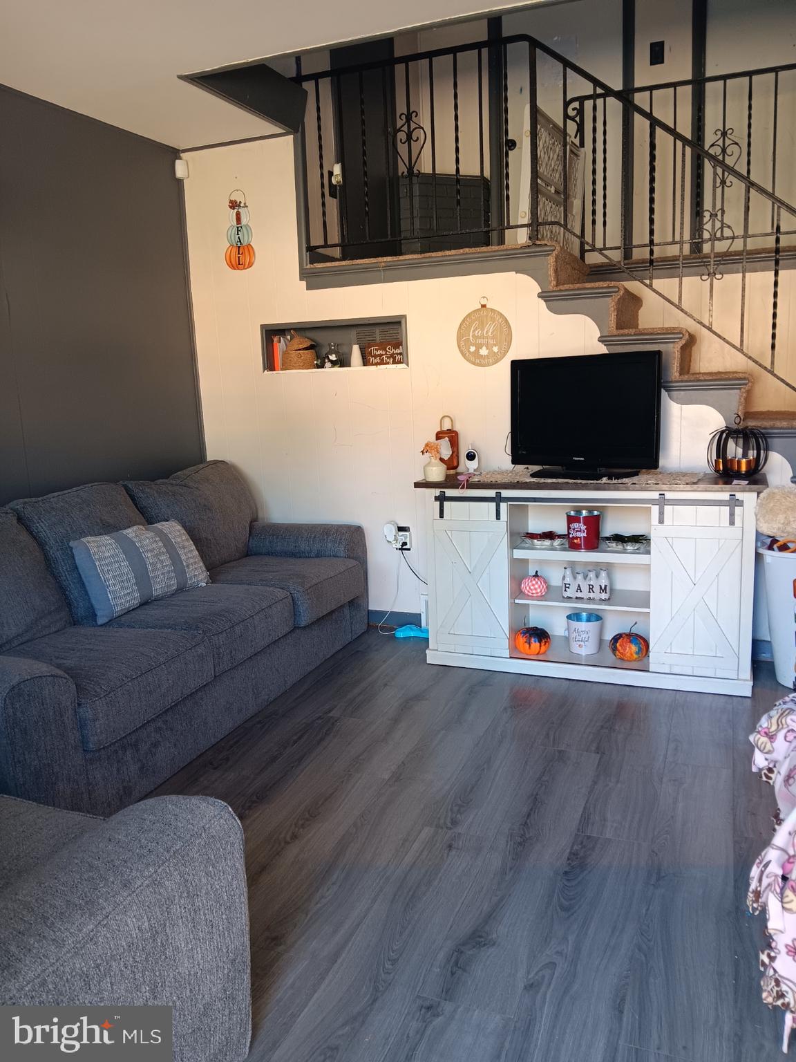 a living room with furniture and a flat screen tv