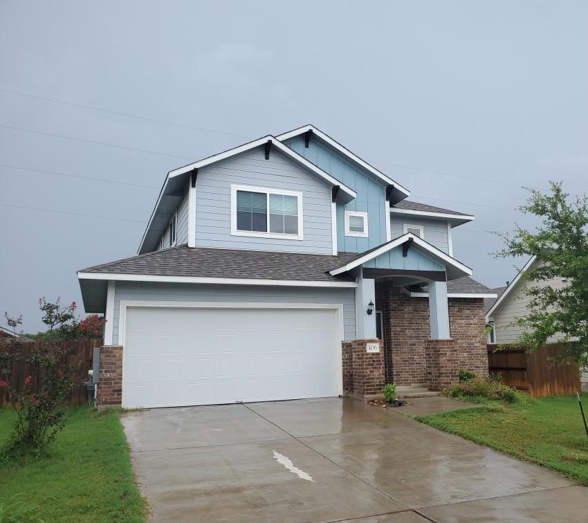 a front view of a house with garage