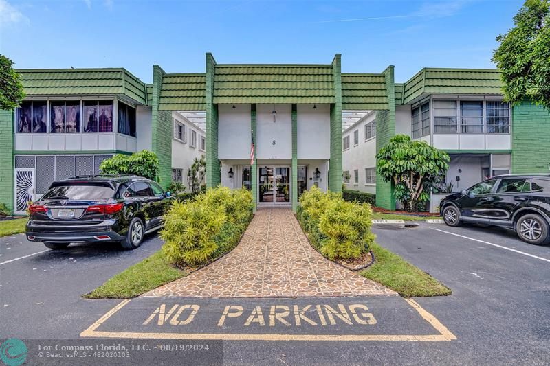 a view of a car park in front of a house