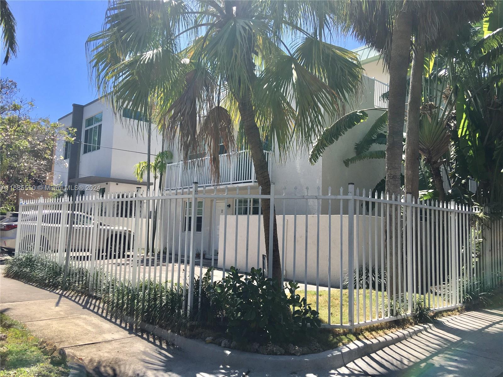 a view of a house with a fence