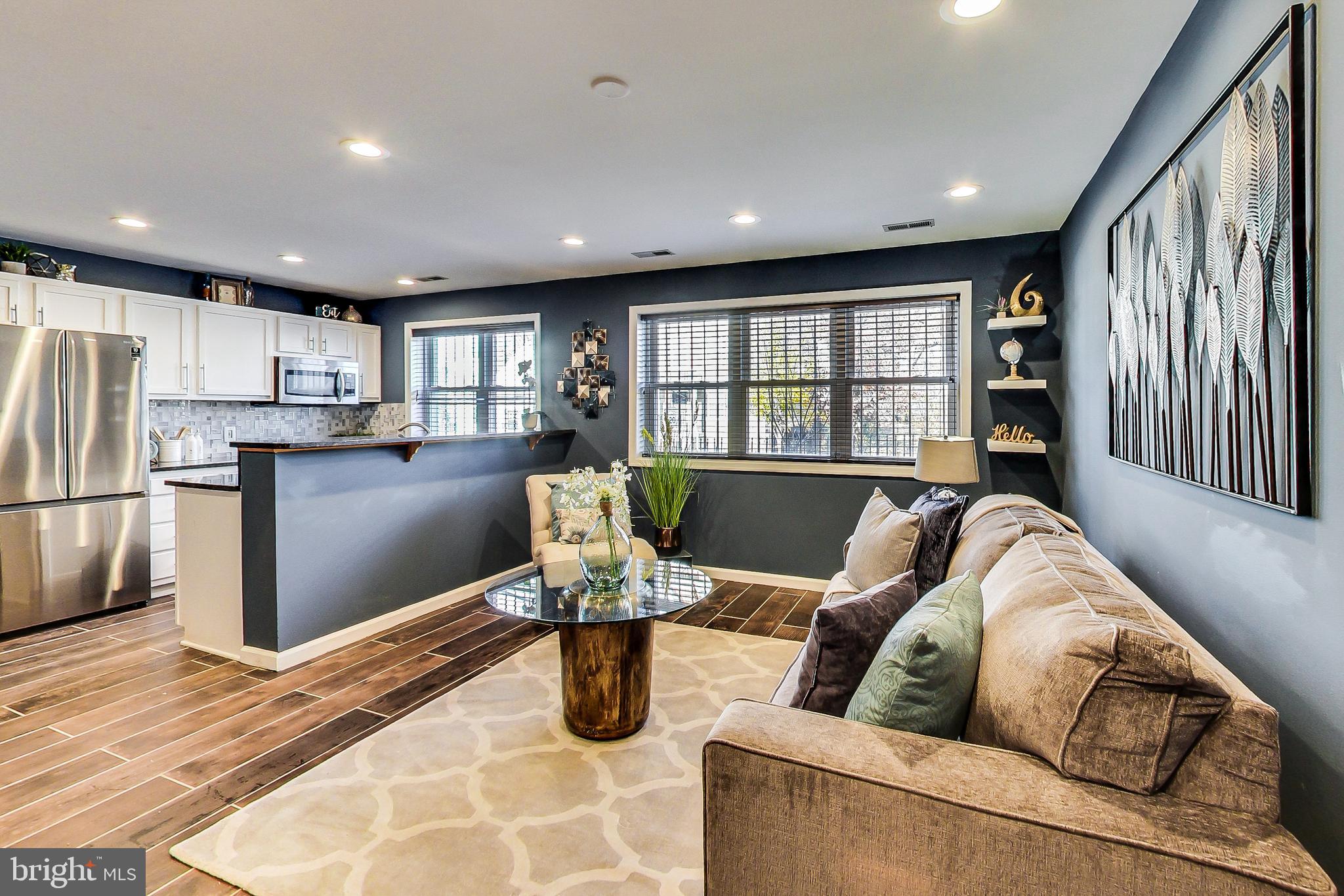 a living room with furniture and a kitchen