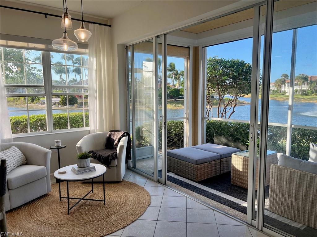 Sunroom featuring a water view