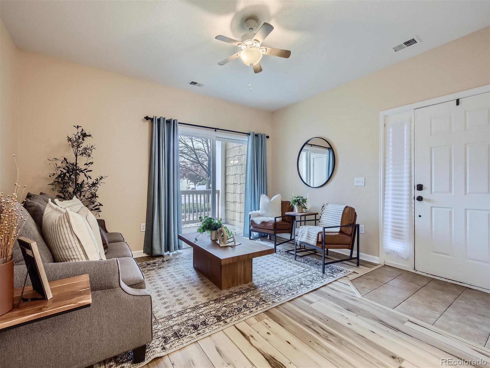 a living room with furniture a rug and a chandelier