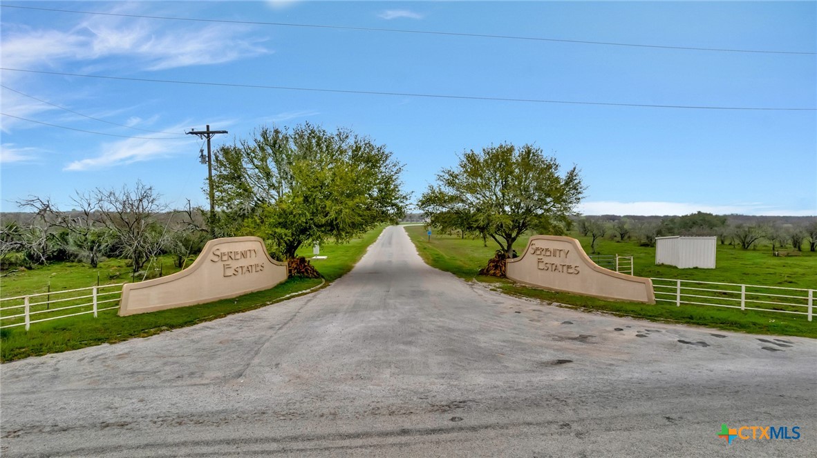 a view of a road with a garden