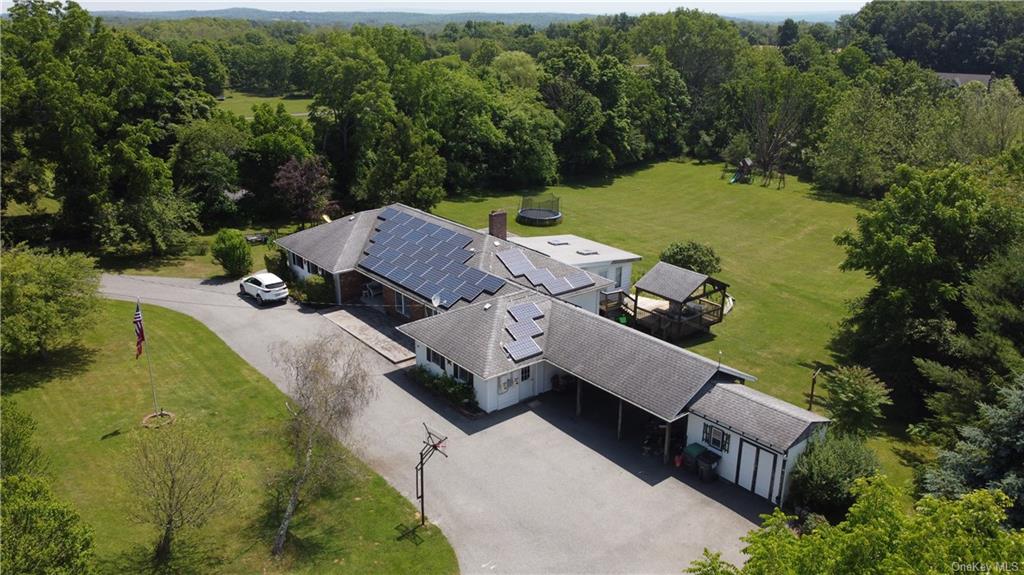 an aerial view of a house with garden space and street view