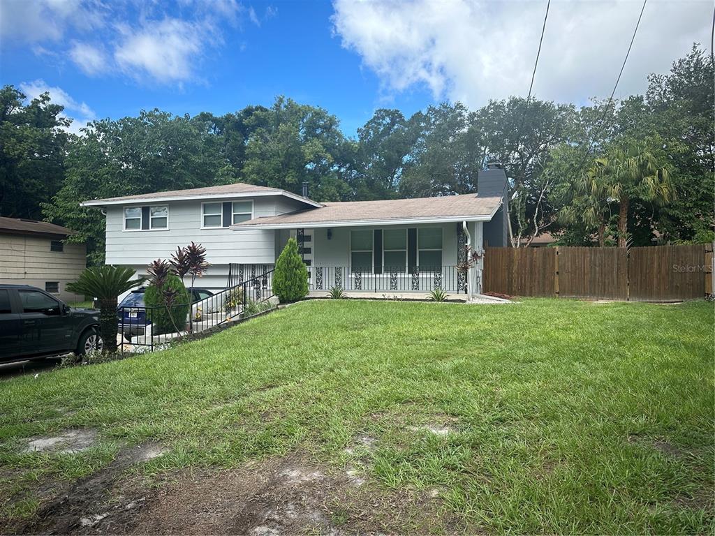 a view of a house with backyard sitting area and garden