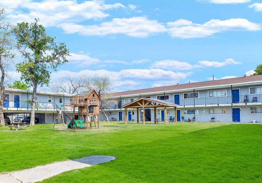 a view of an apartment with a garden and barbeque oven