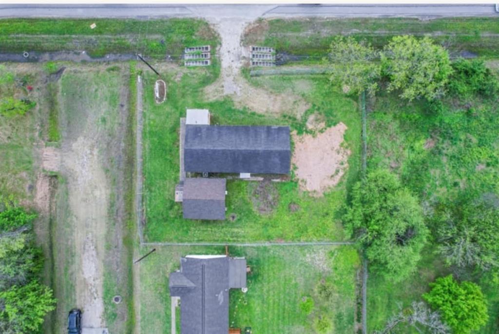 an aerial view of a house with a yard